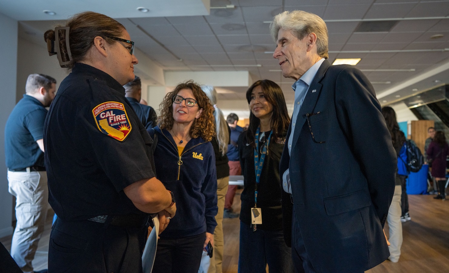 UCLA Chancellor Julio Frenk speaks with a representative of the California Department of Forestry and Fire Prevention at the opening of the disaster recovery center. UCLA Chancellor Julio Frenk speaks with a representative of the California Department of Forestry and Fire Prevention at the opening of the disaster recovery center