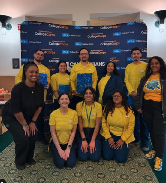 Students and staff with UCLA College Corps at a fire-relief care package event. Nine members of UCLA College Corps pose at a fire-relief care package event.